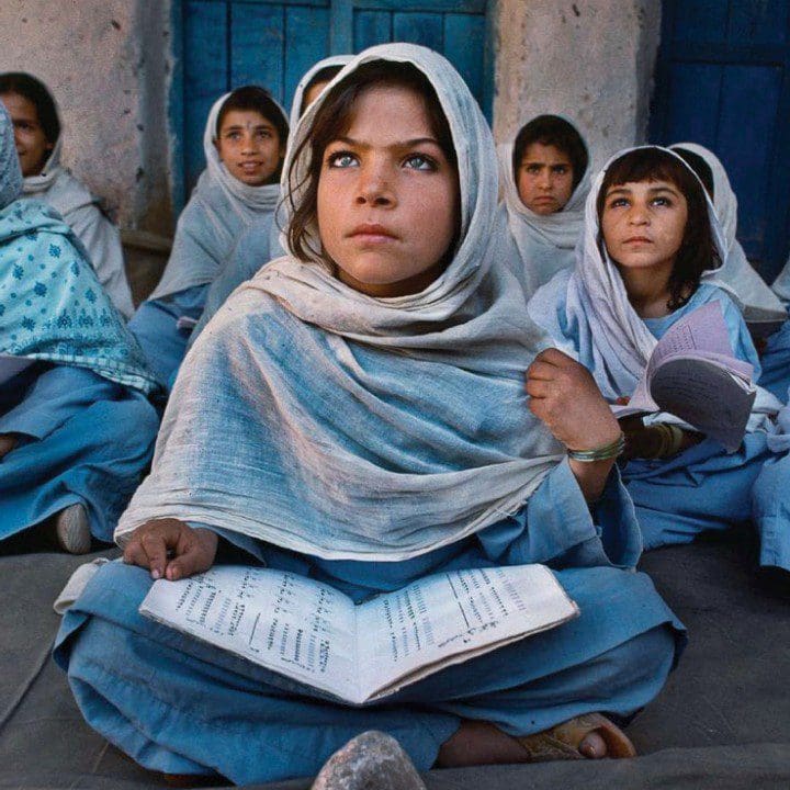 Girl sits with open book