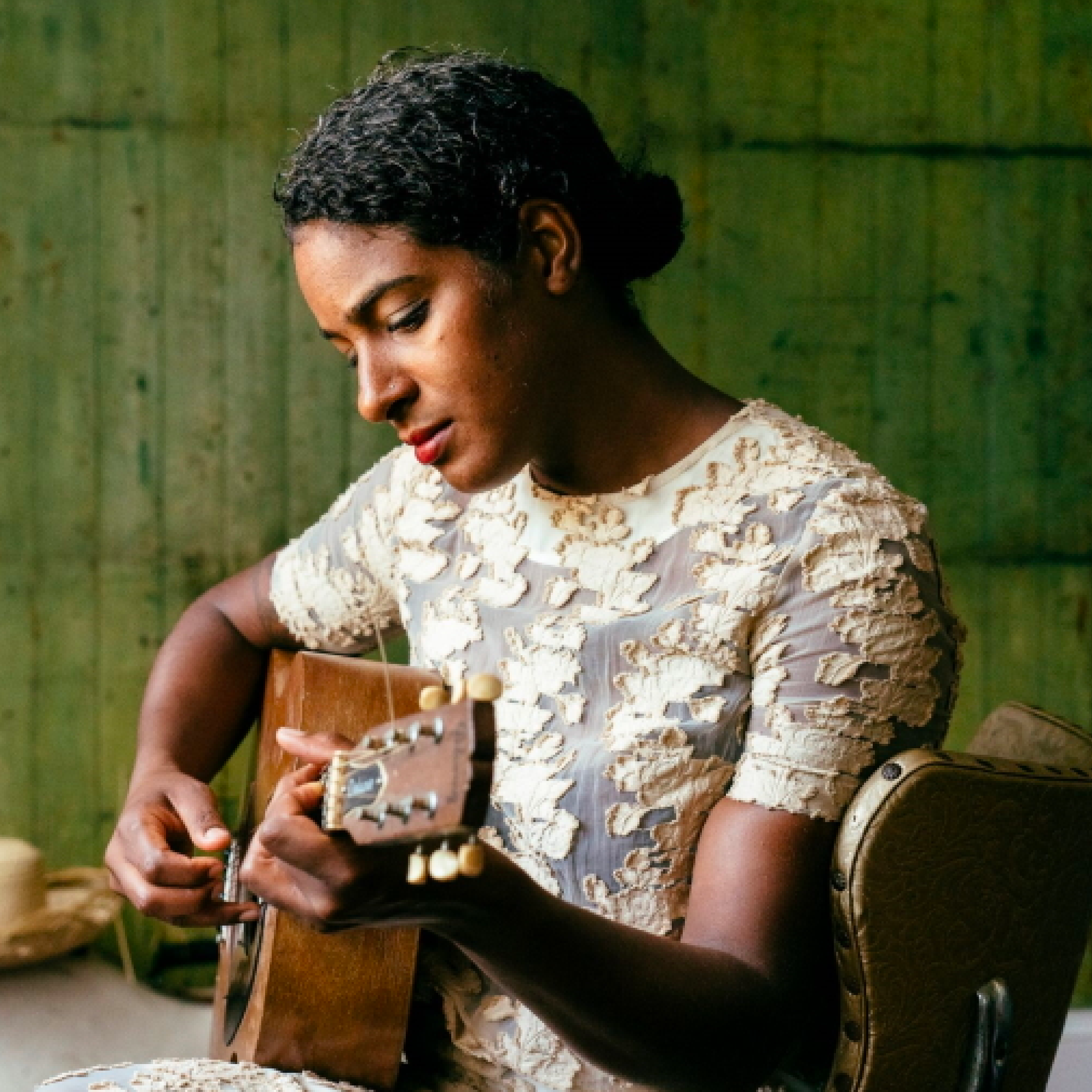 Photo of Layla McCalla playing guitar