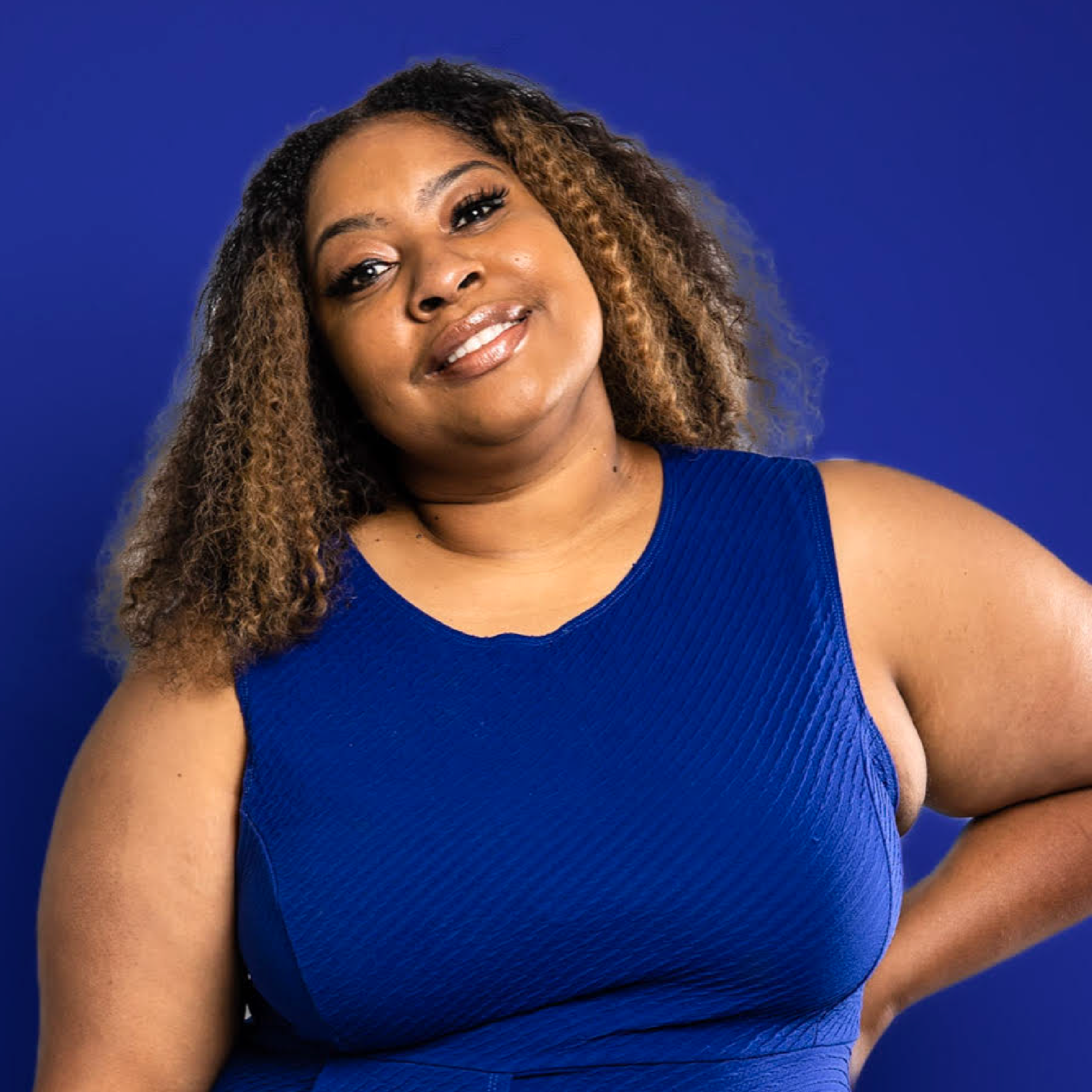 Portrait of Nebu in front of a royal blue background