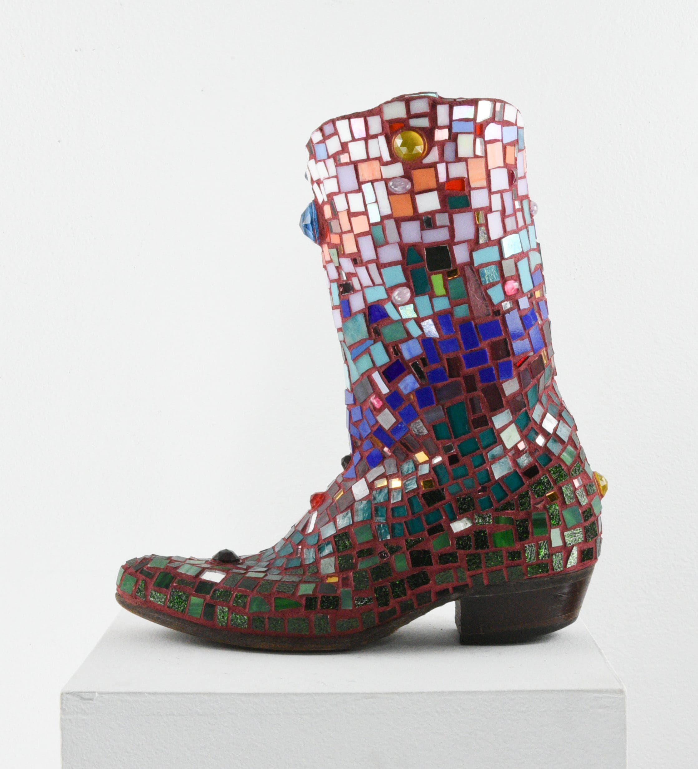 Cowboy boot covered in multi colored mosaic tiles